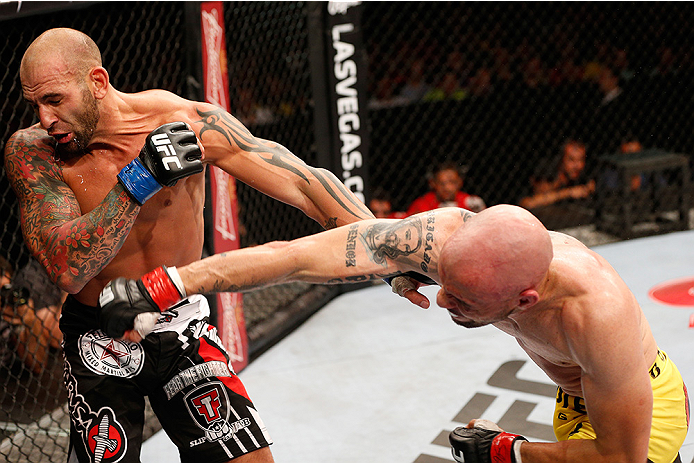 BRASILIA, BRAZIL - SEPTEMBER 13: (R-L) Igor Araujo of Brazil punches George Sullivan in their welterweight bout during the UFC Fight Night event inside Nilson Nelson Gymnasium on September 13, 2014 in Brasilia, Brazil. (Photo by Josh Hedges/Zuffa LLC/Zuff