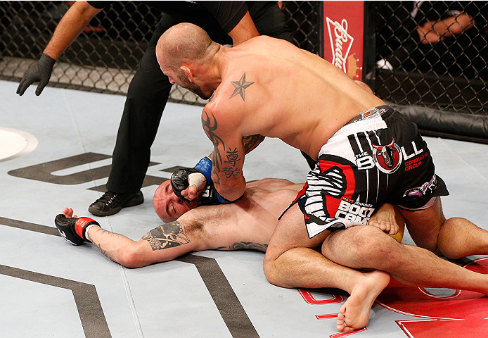 BRASILIA, BRAZIL - SEPTEMBER 13: (R-L) George Sullivan knocks out Igor Araujo of Brazil with a series of punches on the ground in their welterweight bout during the UFC Fight Night event inside Nilson Nelson Gymnasium on September 13, 2014 in Brasilia, Br
