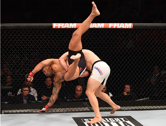 RIO DE JANEIRO, BRAZIL - AUGUST 01: (R-L) Patrick Cummins of the United States takes down Rafael Feijao of Brazil in their light heavyweight bout during the UFC 190 event inside HSBC Arena on August 1, 2015 in Rio de Janeiro, Brazil. (Photo by Josh Hedg