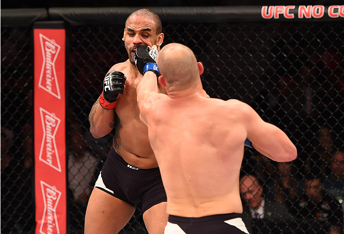 RIO DE JANEIRO, BRAZIL - AUGUST 01: (R-L) Patrick Cummins of the United States punches Rafael Feijao of Brazil in their light heavyweight bout during the UFC 190 event inside HSBC Arena on August 1, 2015 in Rio de Janeiro, Brazil. (Photo by Josh Hedges/