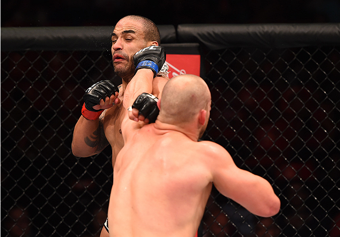 RIO DE JANEIRO, BRAZIL - AUGUST 01: (R-L) Patrick Cummins of the United States punches Rafael Feijao of Brazil in their light heavyweight bout during the UFC 190 event inside HSBC Arena on August 1, 2015 in Rio de Janeiro, Brazil. (Photo by Josh Hedges/