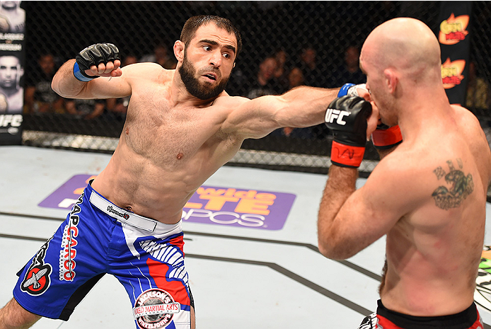 NEW ORLEANS, LA - JUNE 06: (L-R) Omari Akhmedov punches Brian Ebersole in their welterweight bout during the UFC event at the Smoothie King Center on June 6, 2015 in New Orleans, Louisiana. (Photo by Josh Hedges/Zuffa LLC/Zuffa LLC via Getty Images)