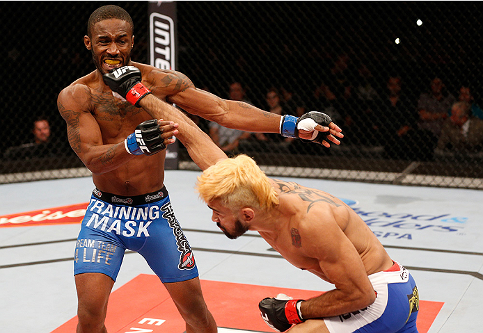 BRASILIA, BRAZIL - SEPTEMBER 13: (R-L) Godofredo Pepey of Brazil punches Dashon Johnson in their featherweight bout during the UFC Fight Night event inside Nilson Nelson Gymnasium on September 13, 2014 in Brasilia, Brazil. (Photo by Josh Hedges/Zuffa LLC/