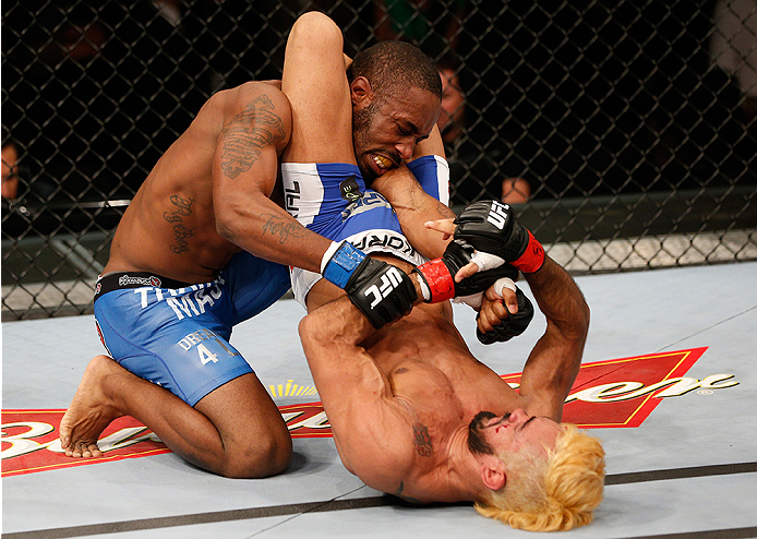 BRASILIA, BRAZIL - SEPTEMBER 13: (R-L) Godofredo Pepey of Brazil secures a triangle arm bar submission against Dashon Johnson in their featherweight bout during the UFC Fight Night event inside Nilson Nelson Gymnasium on September 13, 2014 in Brasilia, Br