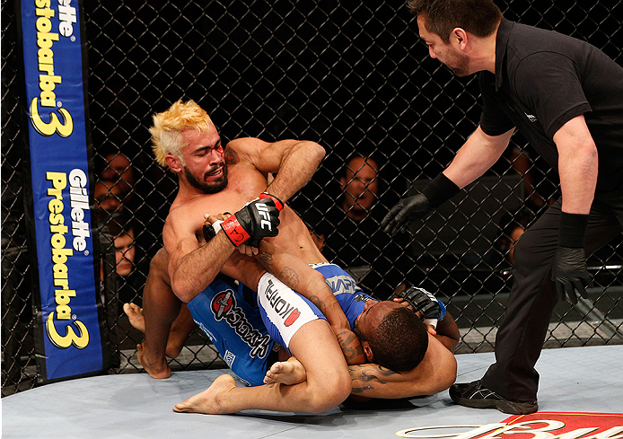 BRASILIA, BRAZIL - SEPTEMBER 13: (L-R) Godofredo Pepey of Brazil secures a triangle arm bar submission against Dashon Johnson in their featherweight bout during the UFC Fight Night event inside Nilson Nelson Gymnasium on September 13, 2014 in Brasilia, Br