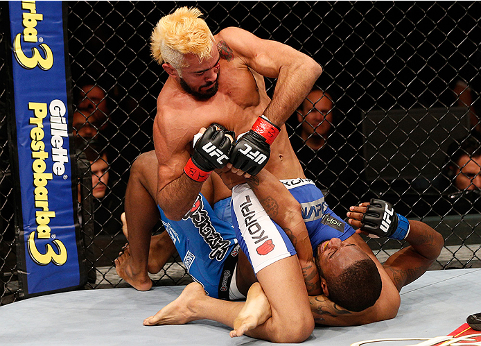 BRASILIA, BRAZIL - SEPTEMBER 13: (L-R) Godofredo Pepey of Brazil secures a triangle arm bar submission against Dashon Johnson in their featherweight bout during the UFC Fight Night event inside Nilson Nelson Gymnasium on September 13, 2014 in Brasilia, Br