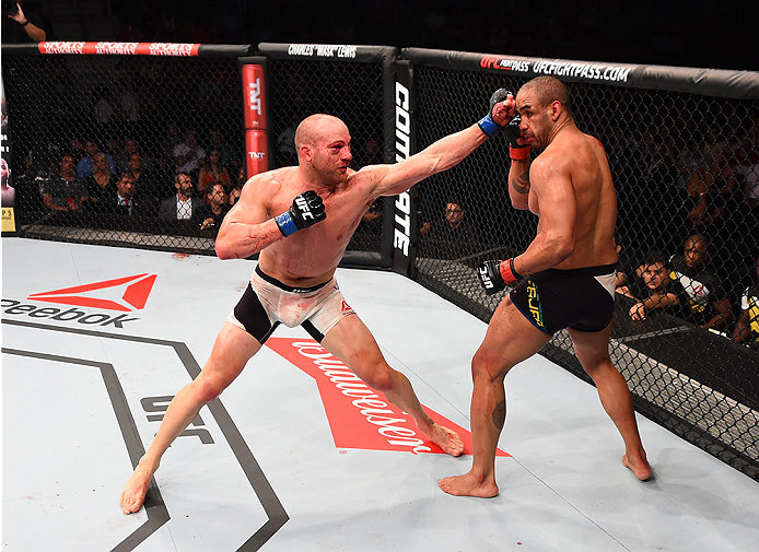 RIO DE JANEIRO, BRAZIL - AUGUST 01: (L-R) Patrick Cummins of the United States punches Rafael Feijao of Brazil in their light heavyweight bout during the UFC 190 event inside HSBC Arena on August 1, 2015 in Rio de Janeiro, Brazil. (Photo by Josh Hedges/