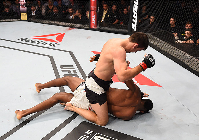 RIO DE JANEIRO, BRAZIL - AUGUST 01: Demian Maia of Brazil (top) punches Neil Magny of the United States in their welterweight bout during the UFC 190 event inside HSBC Arena on August 1, 2015 in Rio de Janeiro, Brazil. (Photo by Josh Hedges/Zuffa LLC/Zu