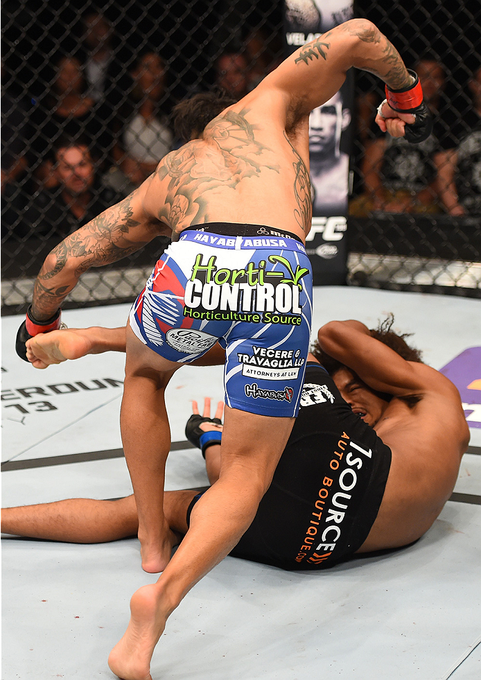 NEW ORLEANS, LA - JUNE 06: Francisco Rivera (top) punches Alex Caceres in their bantamweight bout during the UFC event at the Smoothie King Center on June 6, 2015 in New Orleans, Louisiana. (Photo by Josh Hedges/Zuffa LLC/Zuffa LLC via Getty Images)