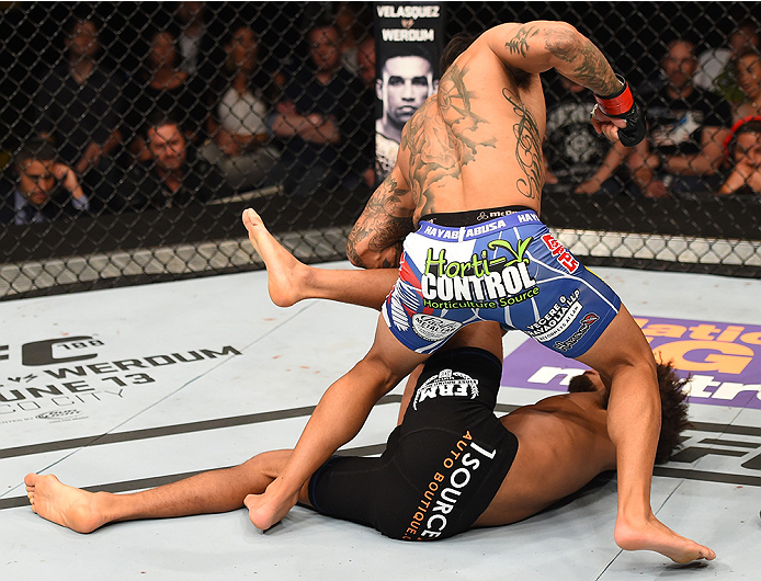 NEW ORLEANS, LA - JUNE 06: Francisco Rivera (top) punches Alex Caceres in their bantamweight bout during the UFC event at the Smoothie King Center on June 6, 2015 in New Orleans, Louisiana. (Photo by Josh Hedges/Zuffa LLC/Zuffa LLC via Getty Images)