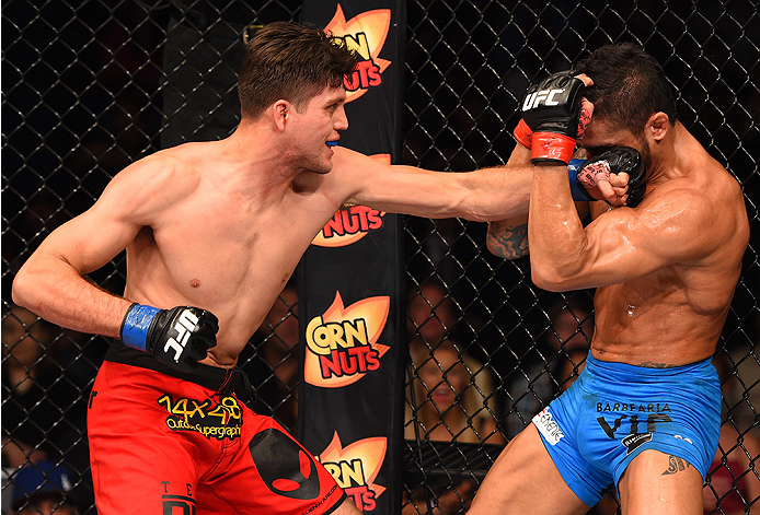 NEW ORLEANS, LA - JUNE 06: (L-R) Brian Ortega punches Thiago Tavares in their featherweight bout during the UFC event at the Smoothie King Center on June 6, 2015 in New Orleans, Louisiana. (Photo by Josh Hedges/Zuffa LLC/Zuffa LLC via Getty Images)