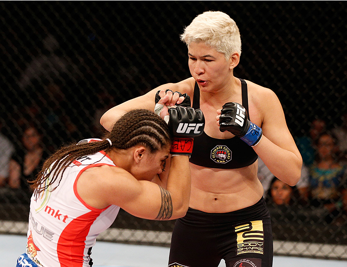 BRASILIA, BRAZIL - SEPTEMBER 13: (R-L) Larissa Pacheco of Brazil punches Jessica Andrade of Brazil in their women's bantamweight bout during the UFC Fight Night event inside Nilson Nelson Gymnasium on September 13, 2014 in Brasilia, Brazil. (Photo by Jo