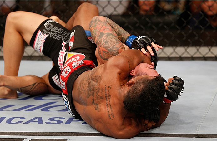 BRASILIA, BRAZIL - SEPTEMBER 13: (L-R) Iuri Alcantara of Brazil attempts to secure a rear choke submission against Russell Doane in their bantamweight bout during the UFC Fight Night event inside Nilson Nelson Gymnasium on September 13, 2014 in Brasilia
