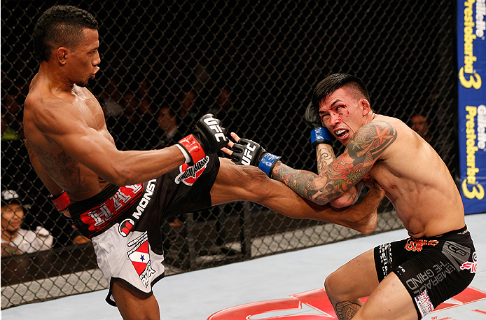 BRASILIA, BRAZIL - SEPTEMBER 13: (L-R) Iuri Alcantara of Brazil kicks Russell Doane in their bantamweight bout during the UFC Fight Night event inside Nilson Nelson Gymnasium on September 13, 2014 in Brasilia, Brazil. (Photo by Josh Hedges/Zuffa LLC/Zuffa