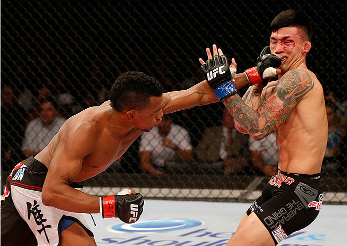BRASILIA, BRAZIL - SEPTEMBER 13: (L-R) Iuri Alcantara of Brazil punches Russell Doane in their bantamweight bout during the UFC Fight Night event inside Nilson Nelson Gymnasium on September 13, 2014 in Brasilia, Brazil. (Photo by Josh Hedges/Zuffa LLC/