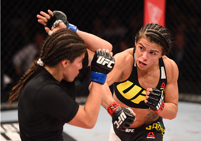 RIO DE JANEIRO, BRAZIL - AUGUST 01: (R-L) Claudia Gadelha of Brazil punches Jessica Aguilar of the United States in their women's strawweight bout during the UFC 190 event inside HSBC Arena on August 1, 2015 in Rio de Janeiro, Brazil. (Photo by Josh Hed