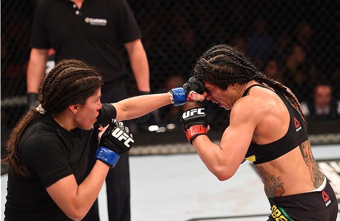 RIO DE JANEIRO, BRAZIL - AUGUST 01: (L-R) Jessica Aguilar of the United States punches Claudia Gadelha of Brazil in their women's strawweight bout during the UFC 190 event inside HSBC Arena on August 1, 2015 in Rio de Janeiro, Brazil. (Photo by Josh Hed