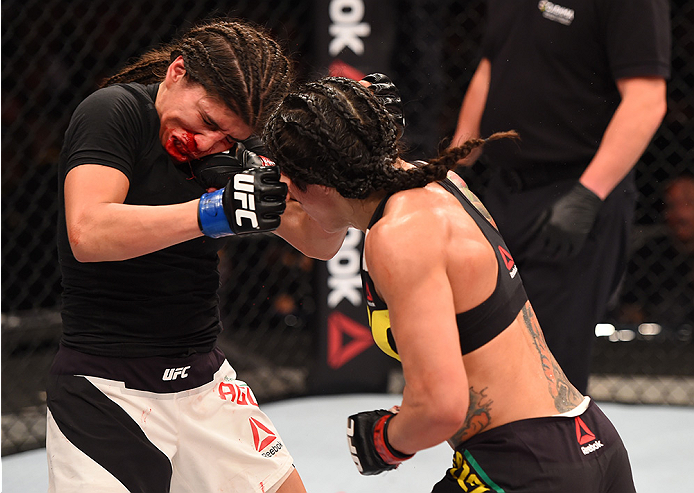 RIO DE JANEIRO, BRAZIL - AUGUST 01: (R-L) Claudia Gadelha of Brazil punches Jessica Aguilar of the United States in their women's strawweight bout during the UFC 190 event inside HSBC Arena on August 1, 2015 in Rio de Janeiro, Brazil. (Photo by Josh Hed