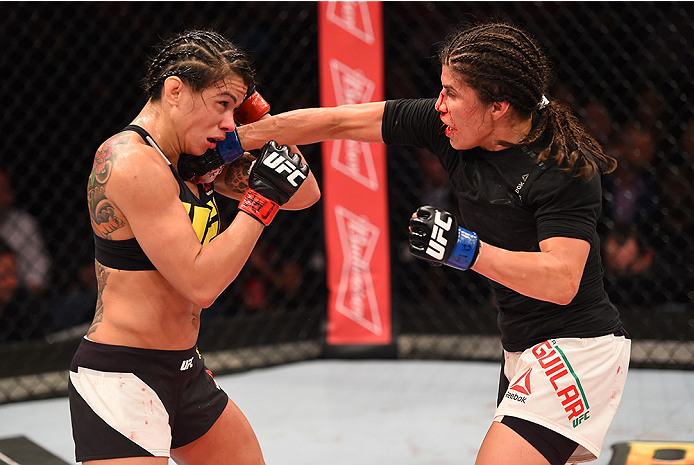 RIO DE JANEIRO, BRAZIL - AUGUST 01: (R-L) Jessica Aguilar of the United States punches Claudia Gadelha of Brazil in their women's strawweight bout during the UFC 190 event inside HSBC Arena on August 1, 2015 in Rio de Janeiro, Brazil. (Photo by Josh Hed
