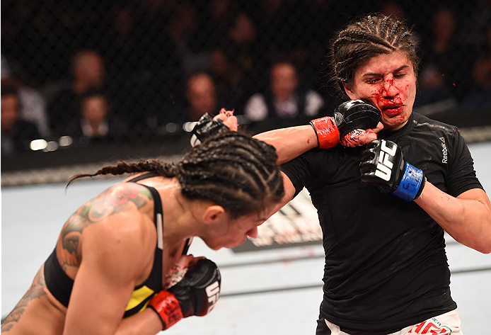 RIO DE JANEIRO, BRAZIL - AUGUST 01: (L-R) Claudia Gadelha of Brazil punches Jessica Aguilar of the United States in their women's strawweight bout during the UFC 190 event inside HSBC Arena on August 1, 2015 in Rio de Janeiro, Brazil. (Photo by Josh Hed
