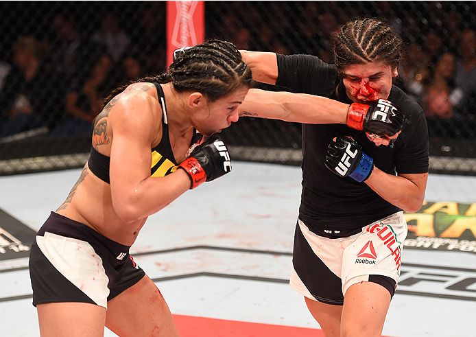 RIO DE JANEIRO, BRAZIL - AUGUST 01: (L-R) Claudia Gadelha of Brazil punches Jessica Aguilar of the United States in their women's strawweight bout during the UFC 190 event inside HSBC Arena on August 1, 2015 in Rio de Janeiro, Brazil. (Photo by Josh Hed