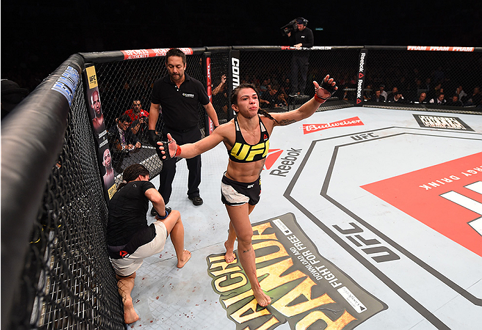 RIO DE JANEIRO, BRAZIL - AUGUST 01: (R-L) Claudia Gadelha of Brazil celebrates her victory over Jessica Aguilar of the United States in their women's strawweight bout during the UFC 190 event inside HSBC Arena on August 1, 2015 in Rio de Janeiro, Brazil.