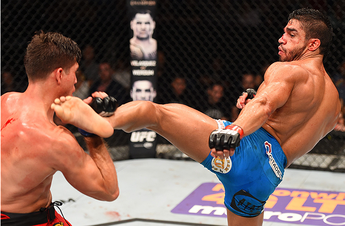 NEW ORLEANS, LA - JUNE 06: (R-L) Thiago Tavares kicks Brian Ortega in their featherweight bout during the UFC event at the Smoothie King Center on June 6, 2015 in New Orleans, Louisiana. (Photo by Josh Hedges/Zuffa LLC/Zuffa LLC via Getty Images)
