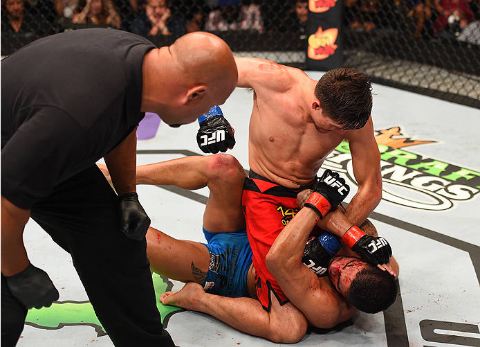 NEW ORLEANS, LA - JUNE 06: Brian Ortega (top)punches Thiago Tavares in their featherweight bout during the UFC event at the Smoothie King Center on June 6, 2015 in New Orleans, Louisiana. (Photo by Josh Hedges/Zuffa LLC/Zuffa LLC via Getty Images)