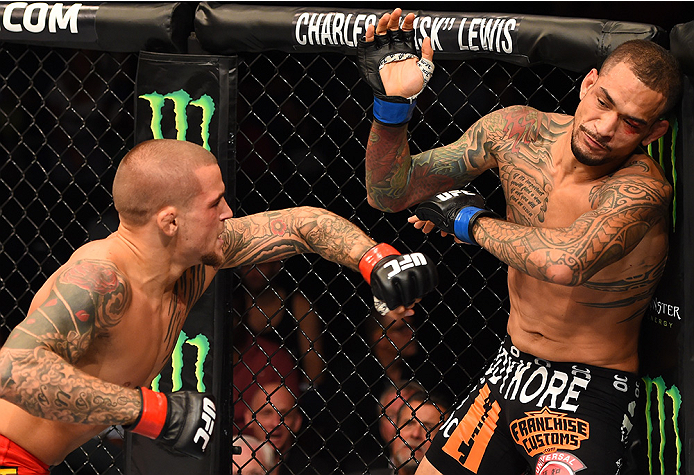 NEW ORLEANS, LA - JUNE 06: (L-R) Dustin Poirier punches Yancy Medeiros in their lightweight bout during the UFC event at the Smoothie King Center on June 6, 2015 in New Orleans, Louisiana. (Photo by Josh Hedges/Zuffa LLC/Zuffa LLC via Getty Images)