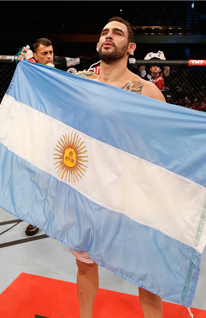 BRASILIA, BRAZIL - SEPTEMBER 13: Santiago Ponzinibbio of Argentina celebrates after his knockout victory over Wendell Oliveira of Brazil in their welterweight bout during the UFC Fight Night event inside Nilson Nelson Gymnasium on September 13, 2014 in