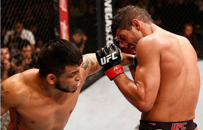 BRASILIA, BRAZIL - SEPTEMBER 13: (L-R) Efrain Escudero of Mexico punches Leonardo Santos of Brazil in their lightweight bout during the UFC Fight Night event inside Nilson Nelson Gymnasium on September 13, 2014 in Brasilia, Brazil. (Photo by Josh Hedges/Z