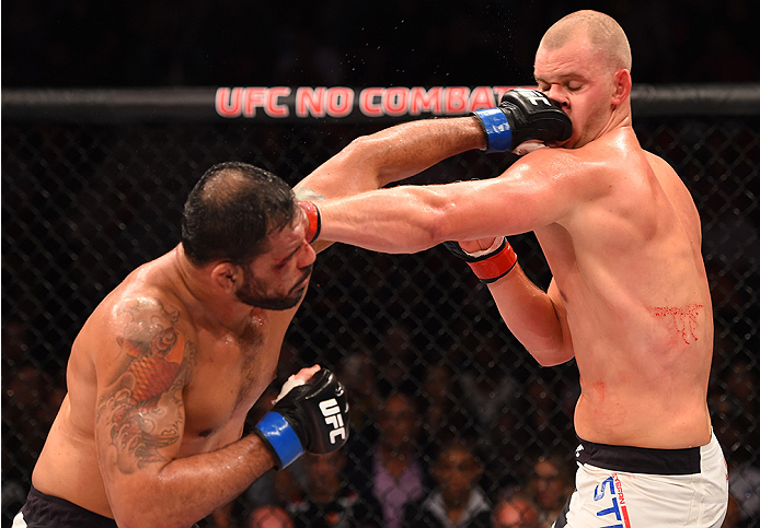 RIO DE JANEIRO, BRAZIL - AUGUST 01: (L-R) Rodrigo 'Minotauro' Nogueira of Brazil punches Stefan Struve of the Netherlands in their heavyweight bout during the UFC 190 event inside HSBC Arena on August 1, 2015 in Rio de Janeiro, Brazil. (Photo by Josh He
