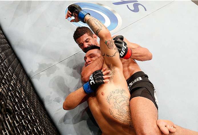 BRASILIA, BRAZIL - SEPTEMBER 13: (R-L) Leonardo Santos of Brazil attempts to secure a rear choke submission against Efrain Escudero of Mexico in their lightweight bout during the UFC Fight Night event inside Nilson Nelson Gymnasium on September 13, 2014 i