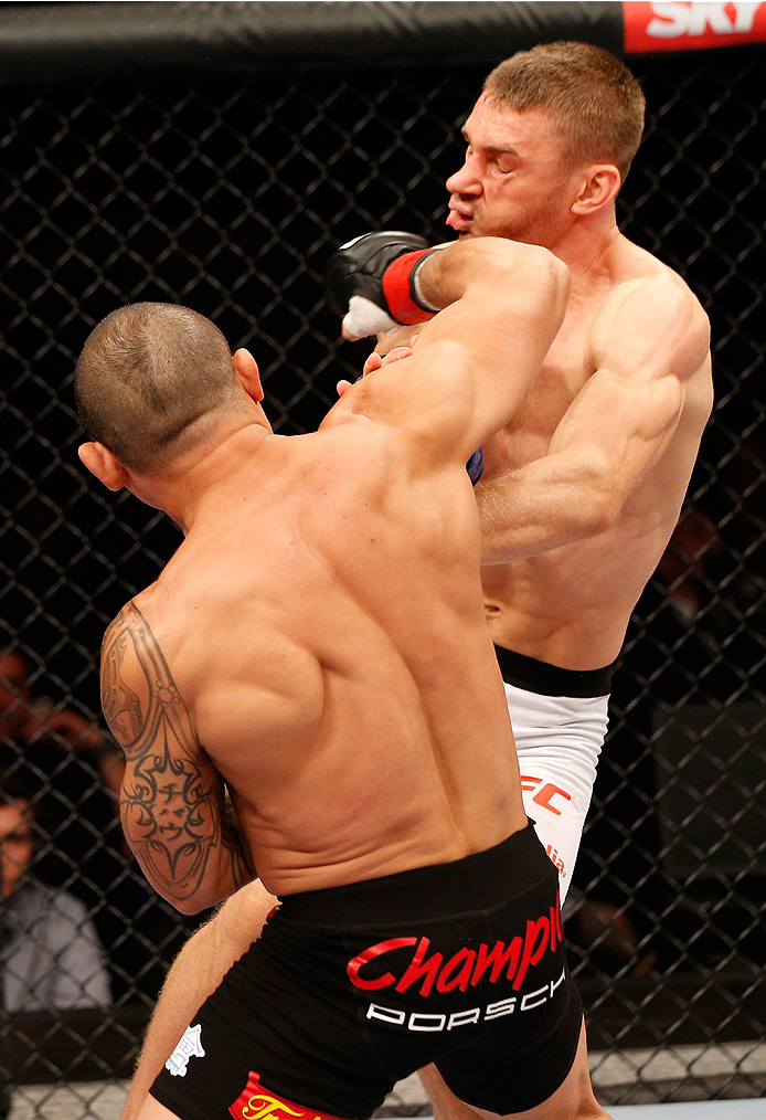 BRASILIA, BRAZIL - SEPTEMBER 13: (L-R) Gleison Tibau of Brazil punches Piotr Hallmann of Poland in their lightweight bout during the UFC Fight Night event inside Nilson Nelson Gymnasium on September 13, 2014 in Brasilia, Brazil. (Photo by Josh Hedges/Zuff