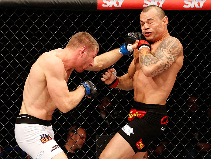 BRASILIA, BRAZIL - SEPTEMBER 13: (L-R) Piotr Hallmann of Poland punches Gleison Tibau of Brazil in their lightweight bout during the UFC Fight Night event inside Nilson Nelson Gymnasium on September 13, 2014 in Brasilia, Brazil. (Photo by Josh Hedges/Zuff