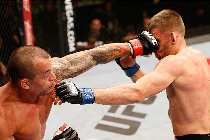 BRASILIA, BRAZIL - SEPTEMBER 13: (L-R) Gleison Tibau of Brazil punches Piotr Hallmann of Poland in their lightweight bout during the UFC Fight Night event inside Nilson Nelson Gymnasium on September 13, 2014 in Brasilia, Brazil. (Photo by Josh Hedges/Zuff