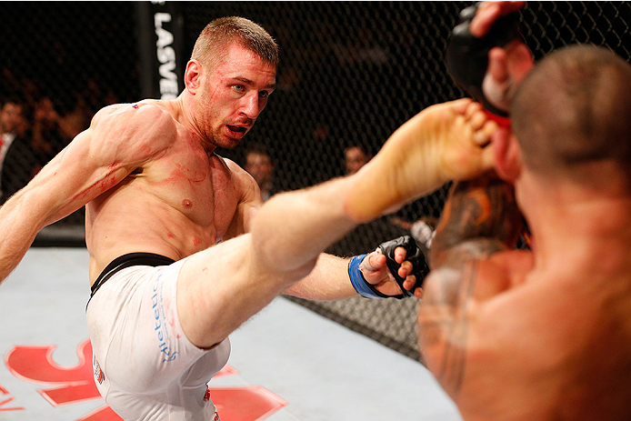 BRASILIA, BRAZIL - SEPTEMBER 13: (L-R) Piotr Hallmann of Poland kicks Gleison Tibau of Brazil in their lightweight bout during the UFC Fight Night event inside Nilson Nelson Gymnasium on September 13, 2014 in Brasilia, Brazil. (Photo by Josh Hedges/Zuffa