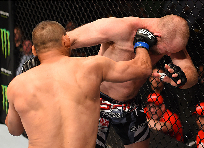 NEW ORLEANS, LA - JUNE 06: (L-R) Dan Henderson punches Tim Boetsch in their middleweight bout during the UFC event at the Smoothie King Center on June 6, 2015 in New Orleans, Louisiana. (Photo by Josh Hedges/Zuffa LLC/Zuffa LLC via Getty Images)
