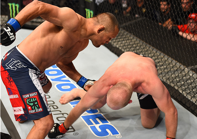 NEW ORLEANS, LA - JUNE 06: (L-R) Dan Henderson punches Tim Boetsch in their middleweight bout during the UFC event at the Smoothie King Center on June 6, 2015 in New Orleans, Louisiana. (Photo by Josh Hedges/Zuffa LLC/Zuffa LLC via Getty Images)