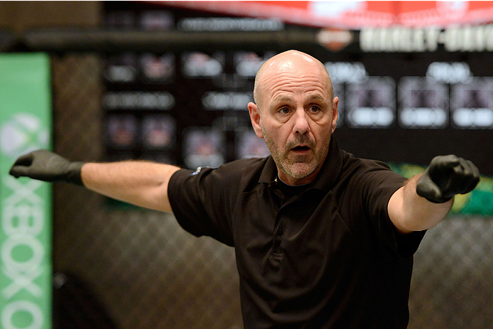 LACHUTE, CANADA - DECEMBER 6: Referee Yves Lavigne signals the start of the fight between Team Canada fighter Kajan Johnson and Team Canada fighter Chad Laprise in their semifinal middleweight fight during filming of The Ultimate Fighter Nations televisi