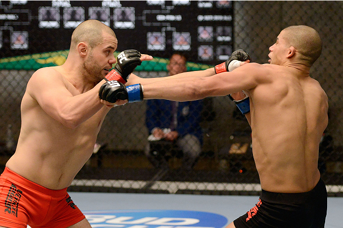 LACHUTE, CANADA - DECEMBER 6: (L-R) Team Canada fighter Chad Laprise punches Team Canada fighter Kajan Johnson in their semifinal middleweight fight during filming of The Ultimate Fighter Nations television series on December 6, 2013 in Lachute, Quebec,