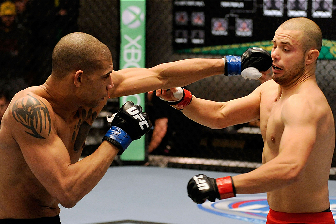 LACHUTE, CANADA - DECEMBER 6: (L-R) Team Canada fighter Kajan Johnson punches Team Canada fighter Chad Laprise in their semifinal middleweight fight during filming of The Ultimate Fighter Nations television series on December 6, 2013 in Lachute, Quebec,