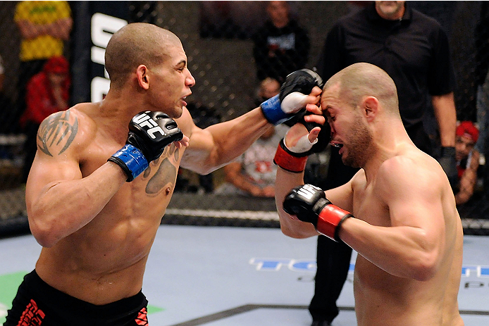 LACHUTE, CANADA - DECEMBER 6: (L-R) Team Canada fighter Kajan Johnson punches Team Canada fighter Chad Laprise in their semifinal middleweight fight during filming of The Ultimate Fighter Nations television series on December 6, 2013 in Lachute, Quebec,