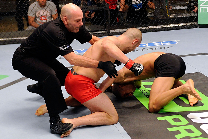 LACHUTE, CANADA - DECEMBER 6: Team Canada fighter Chad Laprise (C) is pulled off of Team Canada fighter Kajan Johnson (R) by referee Yves Lavigne (L) after knocking Johnson out in their semifinal middleweight fight during filming of The Ultimate Fighter