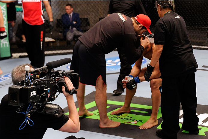 LACHUTE, CANADA - DECEMBER 6: Coach Patrick Cote consoles Team Canada fighter Kajan Johnson after being defeated by Team Canada fighter Chad Laprise in their semifinal middleweight fight during filming of The Ultimate Fighter Nations television series on