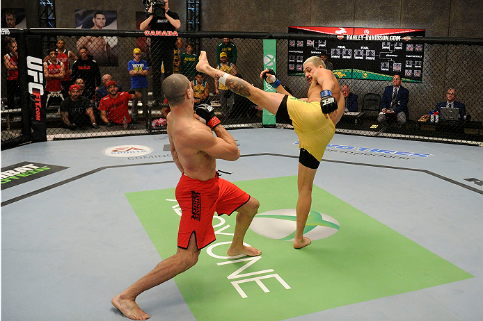 LACHUTE, CANADA - NOVEMBER 11: (R-L) Team Australia fighter Tyler Manawaroa kicks at Team Canada fighter Nordine Taleb in their middleweight fight during filming of The Ultimate Fighter Nations television series on November 11, 2013 in Lachute, Quebec, C