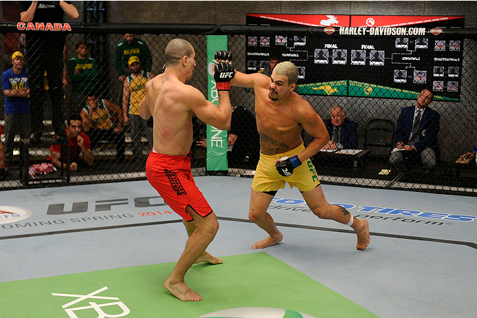 LACHUTE, CANADA - NOVEMBER 11: (R-L) Team Australia fighter Tyler Manawaroa swings at Team Canada fighter Nordine Taleb in their middleweight fight during filming of The Ultimate Fighter Nations television series on November 11, 2013 in Lachute, Quebec,