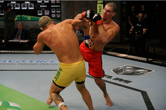 LACHUTE, CANADA - NOVEMBER 11: (L-R) Team Australia fighter Tyler Manawaroa punches Team Canada fighter Nordine Taleb in their middleweight fight during filming of The Ultimate Fighter Nations television series on November 11, 2013 in Lachute, Quebec, Ca