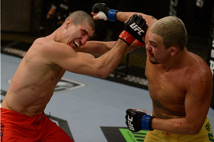 LACHUTE, CANADA - NOVEMBER 11: (R-L) Team Australia fighter Tyler Manawaroa punches Team Canada fighter Nordine Taleb in their middleweight fight during filming of The Ultimate Fighter Nations television series on November 11, 2013 in Lachute, Quebec, Ca