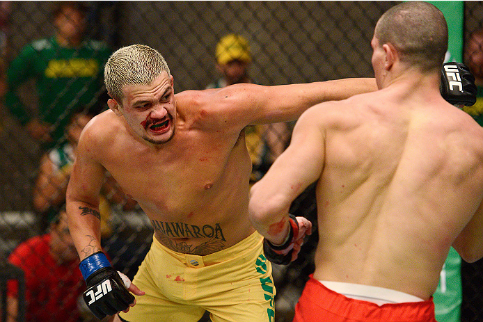 LACHUTE, CANADA - NOVEMBER 11: (L-R) Team Australia fighter Tyler Manawaroa punches Team Canada fighter Nordine Taleb in their middleweight fight during filming of The Ultimate Fighter Nations television series on November 11, 2013 in Lachute, Quebec, Ca